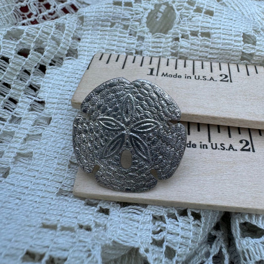 Silver sand dollar scarf clip (1970s)